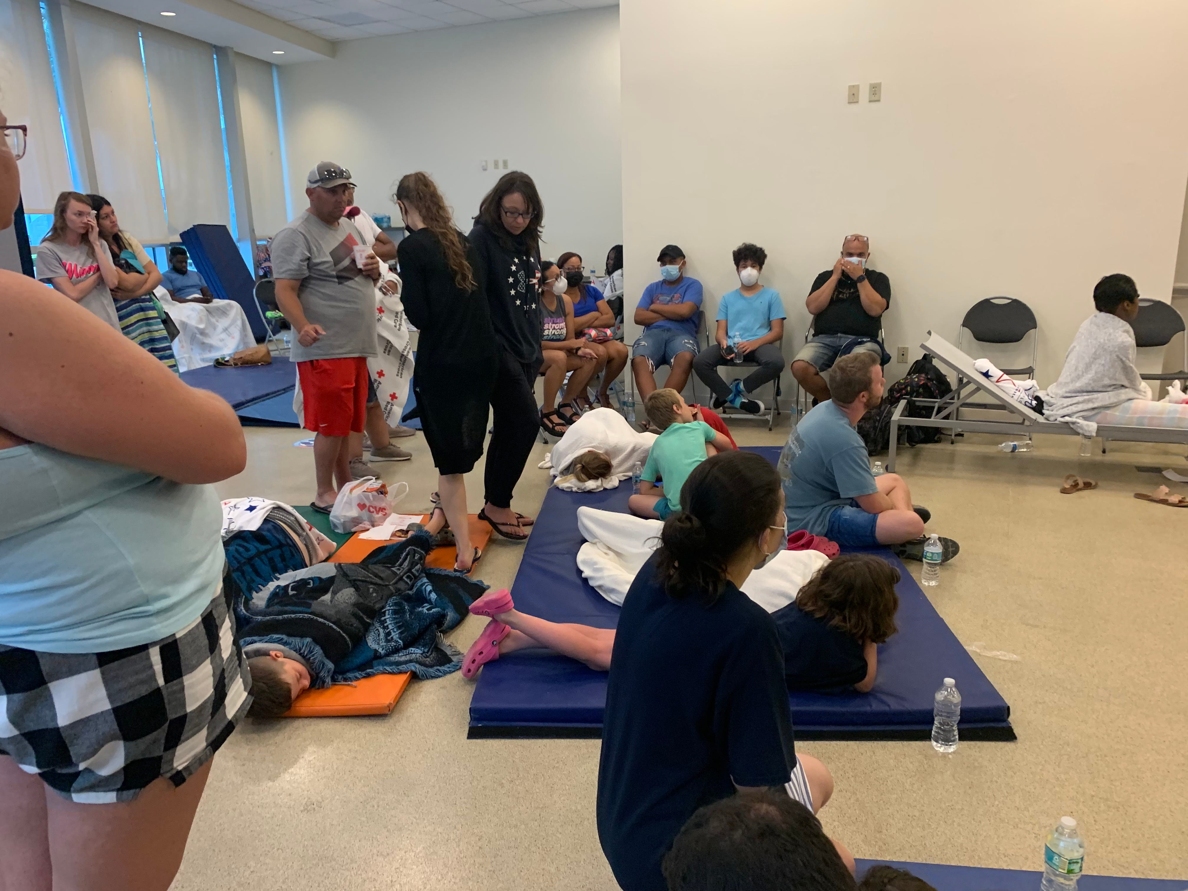 The American Red Cross established a reunion site for family and friends near the site of the partial collapse of a 12-story condominium in Surfside, Florida, early Thursday, June 24, 2021.  About 70 people crowded into a room with chairs and blue exercise mats on the floor.
