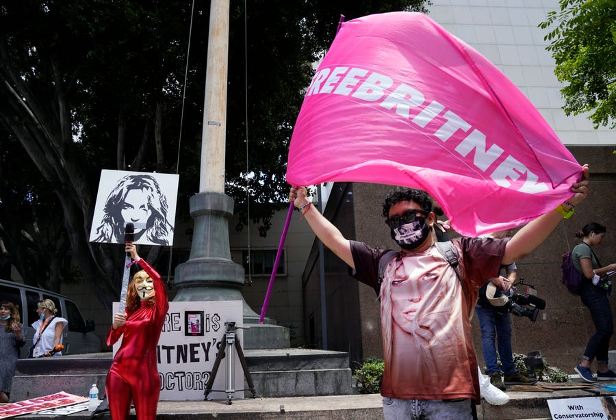 Britney Spears supporters Gabriela Ruiz, left, and Carlos Morales demonstrate outside a court hearing concerning the pop singer's conservatorship at the Stanley Mosk Courthouse.