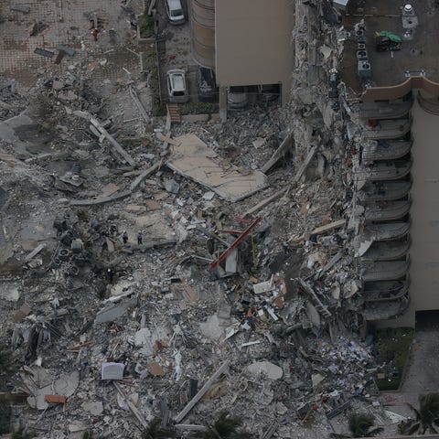 Search and rescue personnel work in the rubble of 