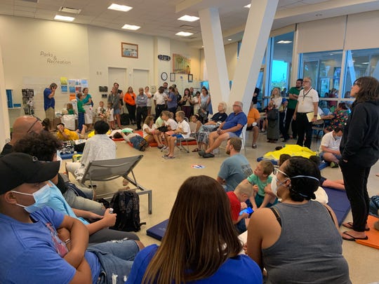 The American Red Cross set up a reunification site for family and friends near the site of the partial building collapse of a 12-story condominium  early Thursday, June 24, 2021 in Surfside, Fla.About 70 people crammed into a room with chairs and blue gym mats on the floor.