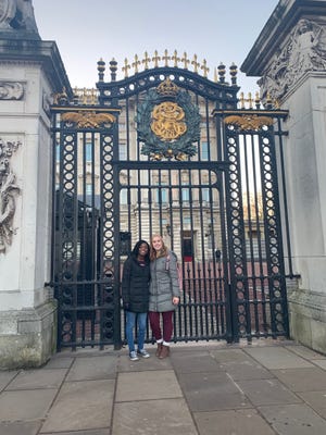 Madi Huffmann and Keishanique Moton-Tyler pose for a photo in front of Buckingham Palace during their winter break vacation in Europe in December 2019.
