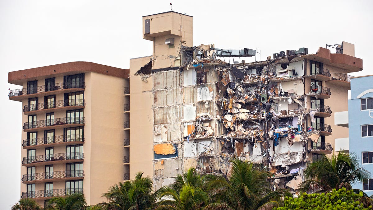 The partially collapsed Champlain Towers South condo is pictured in Surfside, Florida. Families wait to hear news about their loved ones as rescue efforts continued late Thursday
