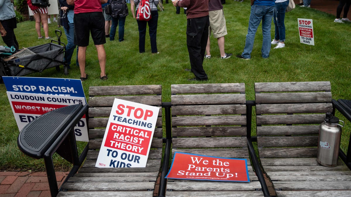 Signs on a bench during a rally against critical race theory being taught in schools at the Loudoun County Government Center in Leesburg, Virginia, on June 12, 2021.