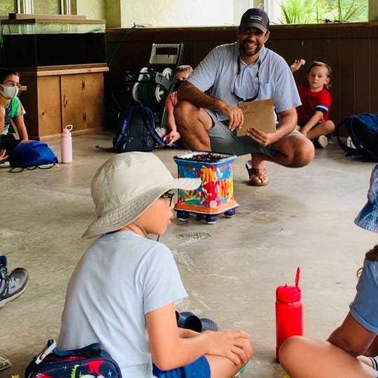 Vik Chhabra with campers at the Calusa Nature Center , to which the One Flower Project just donated pollinator seed kits.