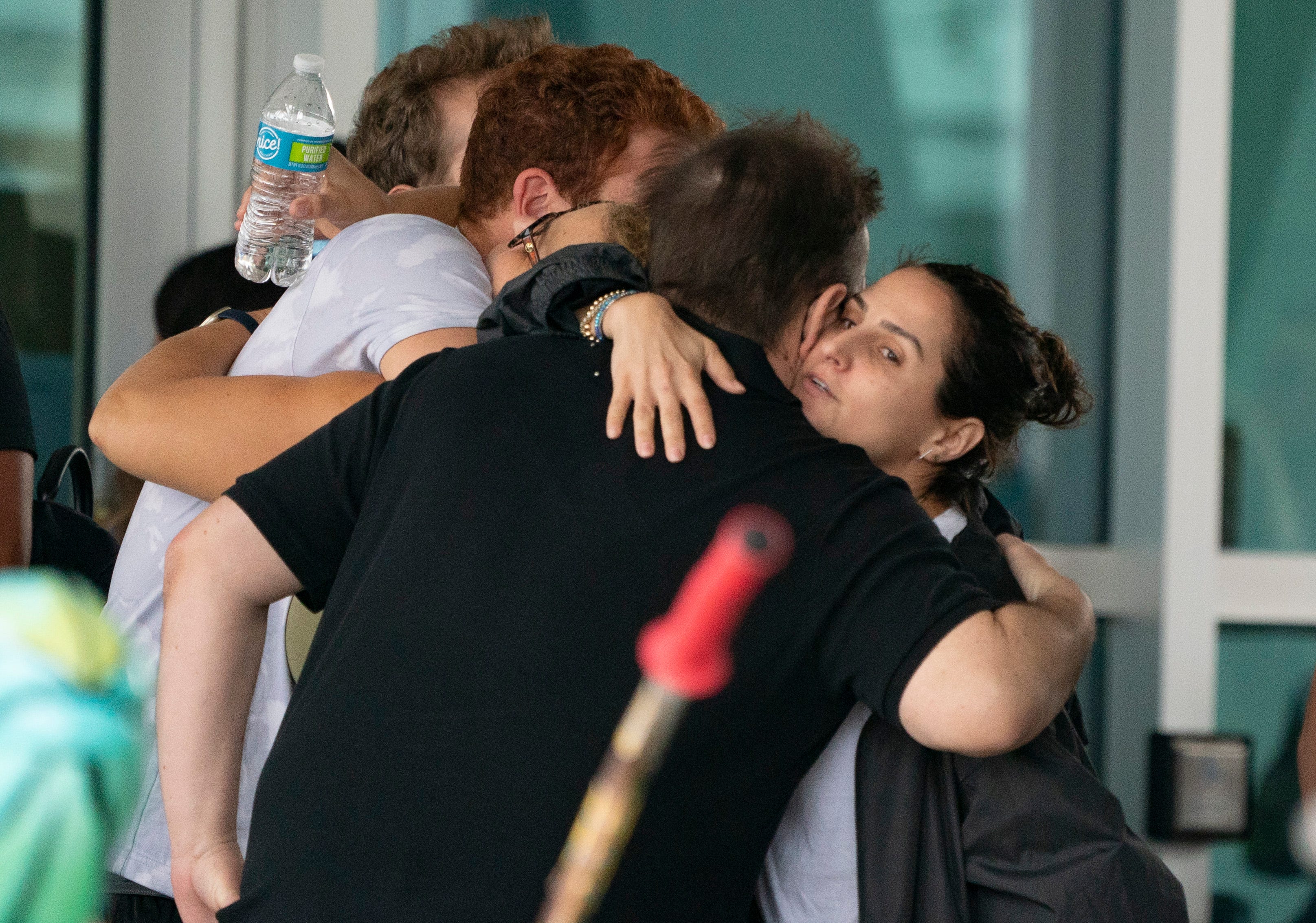 People embrace outside the Surfside Community Center as they wait for news on June 25, 2021 in Surfside, Florida.  The 12-story Champlain Towers South Condo building partially collapsed in Surfside on Thursday.