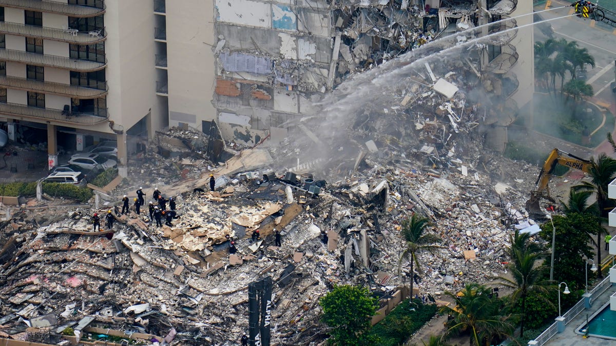 Rescue workers work in the rubble at the Champlain Towers South Condo is seen, Friday, June 25, 2021, in Surfside.