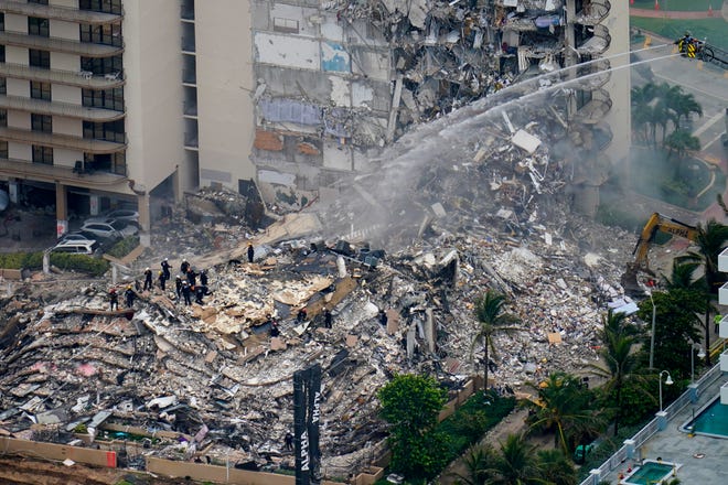 Rescue workers work in the rubble of the Champlain Towers South Condo, Friday, June 25, 2021, in Surfside, Florida.