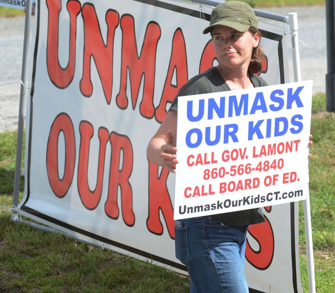 Elin Hill of Bozrah and about a dozen people protest mandatory masks Friday for the fall session at Fields Memorial School in Bozarh. [John Shishmanian/ NorwichBulletin.com]