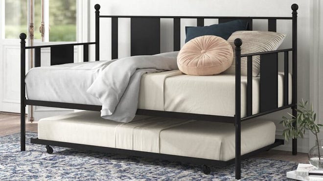 This elegant bed with casters gives any room a luxurious feel.