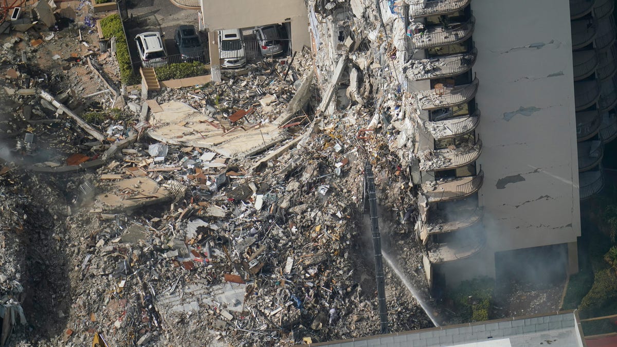 Rescue workers search in the rubble at the Champlain Towers South Condo, Saturday, June 26, 2021, in Surfside, Fla.