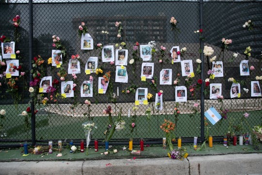 A memorial honoring those unaccounted for after a 12-story building collapsed on display near the collapse site in Surfside, Fla. on June 26, 2021. 