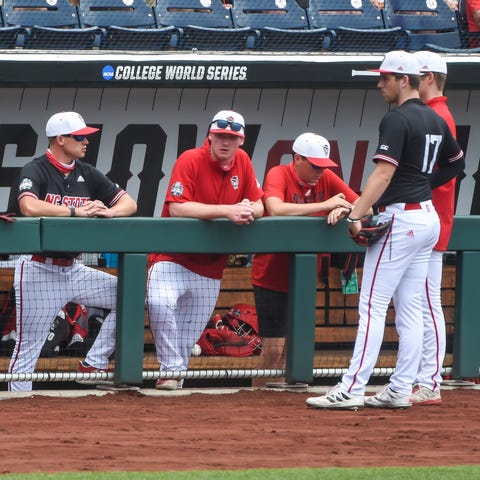 N.C. State players wait out a delay due to players