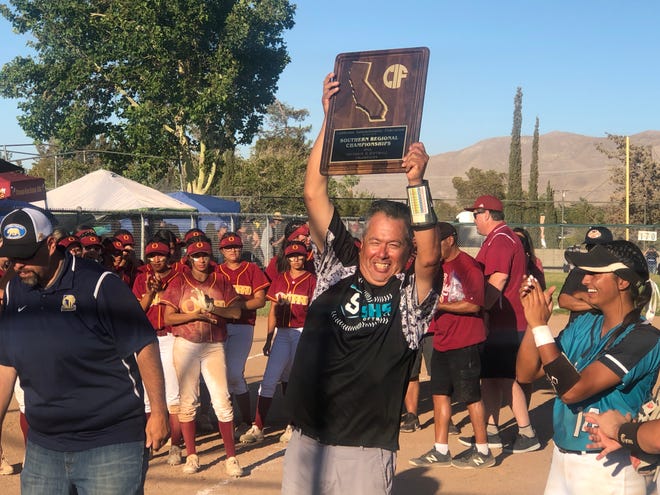 Sultana head coach Obie Galindo celebrates after the softball team beat Oxnard in the CIF State Regional Division 2 title game.