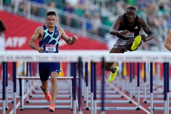 Grant Holloway, right, wins the final in the men's 110-meter hurdles ahead of Devon Allen at the U.S. Olympic Track and Field Trials Saturday, June 26, 2021, in Eugene, Ore. (AP Photo/Ashley Landis)