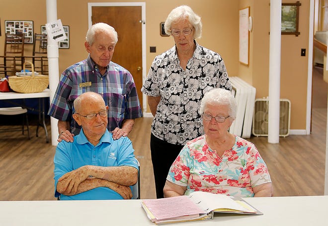 William and Betty Harner, seated, along with Ron Bromeier and Sara Dinsmore go over the registration for an Senior Citizen Center bus trip. These members serve as volunteers to register travelers for the Senior Citizen Center’s one-day-bus-trips.