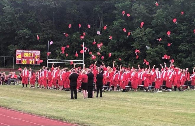 Canisteo-Greenwood's Class of 2021 tosses their graduation caps into the air at the conclusion of commencement ceremonies Friday evening.