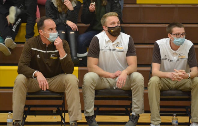 Pellston varsity boys basketball coach Larry Cassidy, far left, along with assistant coaches Nate Meinke and Jared Anderson, look on from the bench during a basketball matchup from this past season. Meinke, middle, has been hired as Pellston's new varsity boys head coach, replacing Cassidy, who guided the Hornets for the last eight seasons.