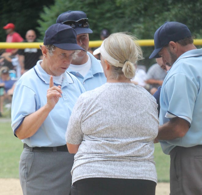 Billerica Memorial High School softball coach Patty Higgins listens to a statement following a Peabody protest against a substitution in the seventh inning.