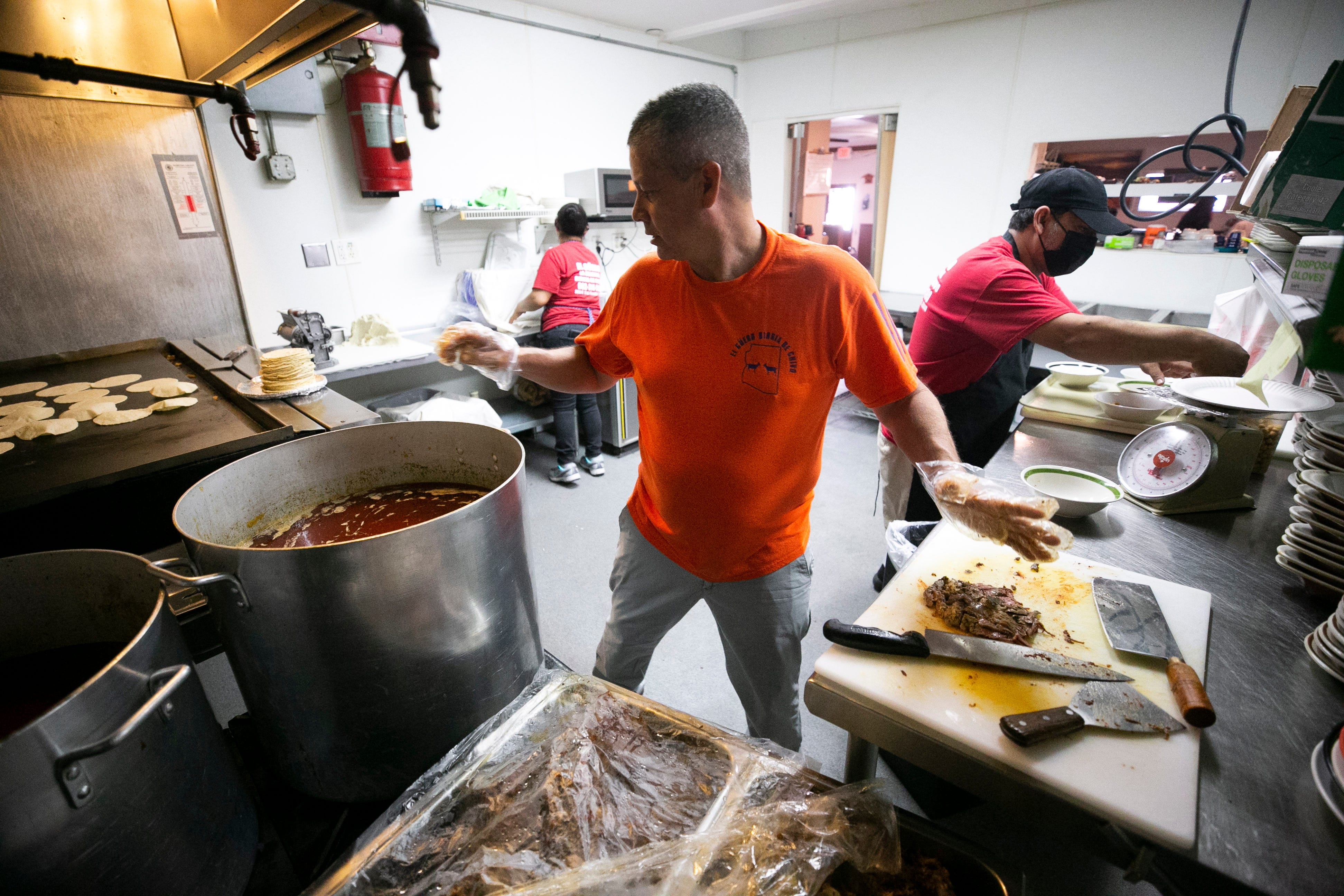 Jose Luis Garcia, owner and chef, prepares birria (stewed goat meat) at El Güero Birria de Chivo restaurant in south Phoenix on June 18, 2021.