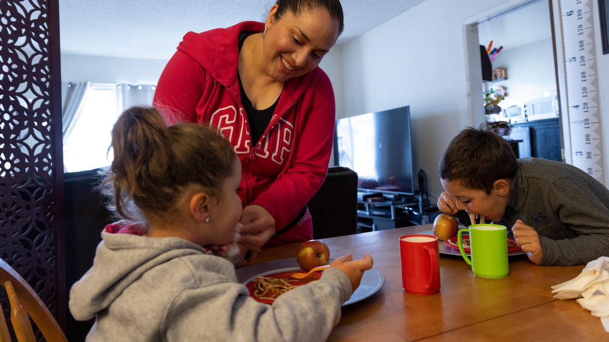 Lily Marquez, a married mother of two makes dinner for her family in San Francisco, Calif. on June 25, 2021.