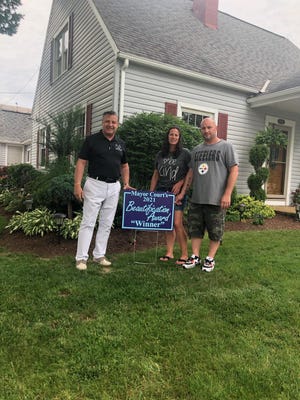 Ellwood City Mayor Anthony Court (left) recently presented the third winner of the "Mayor Court Beautification Award" to Audrey and Chris Otlowski of 300 Johnston Drive in the borough. There will be three more winners chosen for the award this summer.