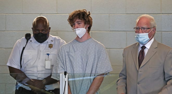 Jack Callahan, 19, center, was charged with murder stemming from the death of his father, whose body was pulled from Island Creek Pond in Crooker Memorial Park in Duxbury in June. His attorney, Kevin Reddington, is at right.