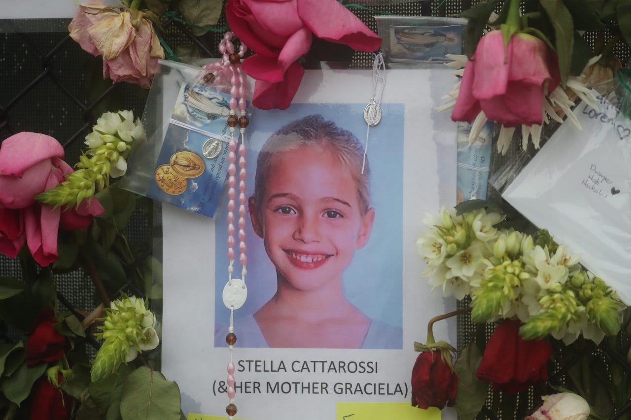 Shown is Stella Cattarossi with a note about her mother, Graciela Cattarossi, Graciela Maria Cattarossi or Graciella Cattarossi (spelling unknown). Graciela Cattarossi died in the Surfside condo collapse. Her body was recovered July 2, 2021. Posters of some of the people missing from the Champlain Towers south condo collapse were photographed June 28, 2021, at the memorial fence.