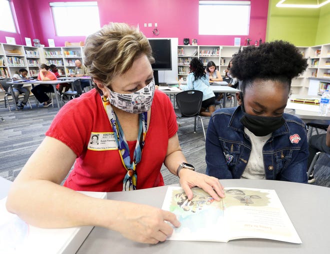 Volunteers with the Reading Allies program help students at Martin Luther King Jr. Elementary develop reading skills Monday, June 28, 2021. The effort is part of the initiative to get all students reading on grade level by third grade. Susan Fleming helps Jazmyne Moore with her reading skills. [Staff Photo/Gary Cosby Jr.] 