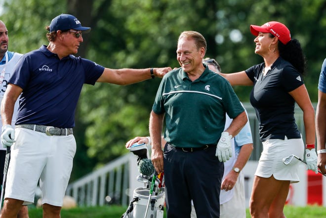 Phil Mickelson fist bumps Shasta Averyhardt next to Tom Izzo at the 15th tee box during the AREA 313 Celebrity Scramble at the Detroit Golf Club in Detroit, Tuesday, June 29, 2021.