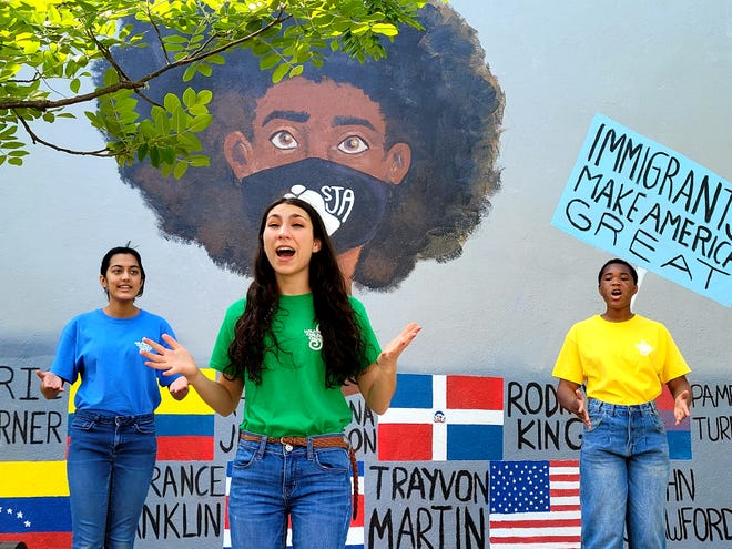 Wilmington Children's Chorus choristers film scenes for their documentary film at the Latin American Community Center mural.