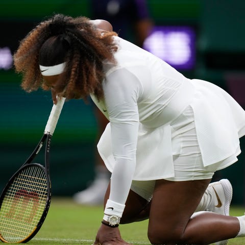 Serena Williams falls to the ground during her fir