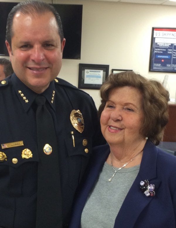 Hilda Noriega and her son, North Bay Village Police Chief Carlos Noriega, at his swearing-in ceremony. Hilda Noriega was found dead after the Surfside condo collapsed. She was 92.