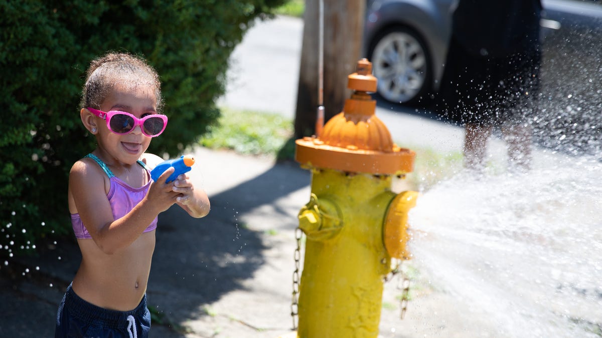 Aurora DePauw, 3, plays in an open hydrant on 3rd and Bush streets in the City of Newburgh, NY, on Wednesday June 30, 2021. According to Newburgh's mayor, Torrance Harvey, due to the city's inability to repair the city pool, they will open hydrants on summer days.