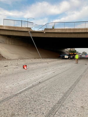 This photo provided by the California Highway Patrol Rancho Cucamonga shows a damaged concrete barrier on a Southern California overpass where a pickup truck crashed onto the road below on Tuesday, June 29, 2021, in Fontana, Calif.