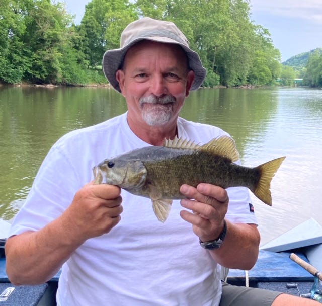 Kevin Strother shows off the first fish caught on a recent float trip down the Mohican River with outdoor correspondent Art Holden. Together, the two caught 41 fish, including three bonus saugeye.