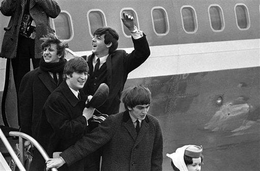Britain's Beatles make a windswept arrival in New York on Feb. 7, 1964. From left to right, Ringo Starr, John Lennon, Paul McCartney and George Harrison.