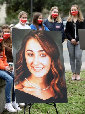 A photograph of Maggie Paxton, a UF student who died in a pedestrian crash along West University Avenue earlier this year, during a press conference where attorneys for the families read a statement from the families, in Gainesville Fla. March 3, 2021. Attorneys for the families have filed wrongful death lawsuits against the drivers and car owners in the crash.