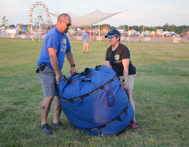 Andrea Boughton of Marshall and pilot Mike Heffron pull the balloon envelope in place before an inflation.