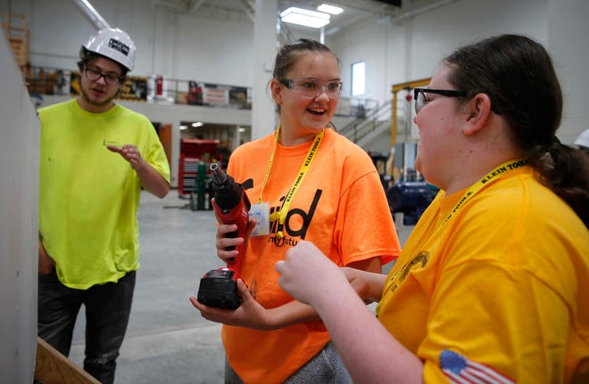 Katherine Zihala, left, and Delanee Stuve learn how to properly operate a power drill during a summer construction camp for girls on Thursday, July 1, 2021, at the Carpenters Local 106 Union building in Altoona. The weeklong construction workshop was offered by the Department of Education with the goal of getting young women interested in entering the field.