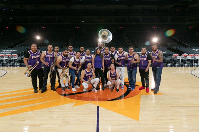 Members of Phoenix-based Banda La Alterada pose with Suns marketing coordinator Chelsea Chaidez after recording a video from Suns Arena for their corrido, 