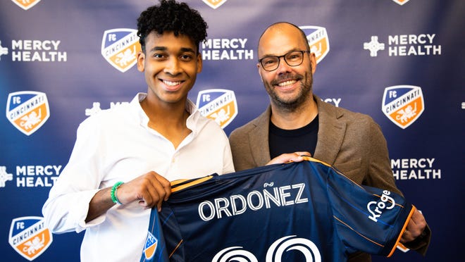Arquimides Ordonez (left), a 17-year-old product of FC Cincinnati's academy, poses for a picture with club General Manager, Gerard Nijkamp.