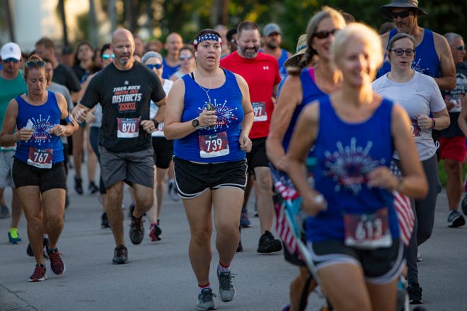 Marissa Foreman, center, joins over 500 participants in this year's Gulf Coast Runners Firecracker 5K race, Saturday, July 3, 2021, in Naples' Lake Park neighborhood.