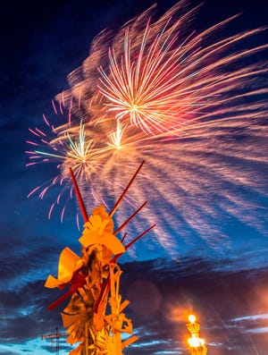 Fireworks explode over the Tribute to Volunteerism sculpture on Lake Mirror in downtown Lakeland on July 3. The show was the first in two years, and drew large crowds.