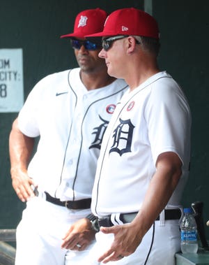 Detroit Tigers bench coach George Lombard, left, and manager AJ Hinch speak in dugout during the second round against the Chicago White Sox at Comerica Park in Detroit, Sunday, July 4, 2021.
