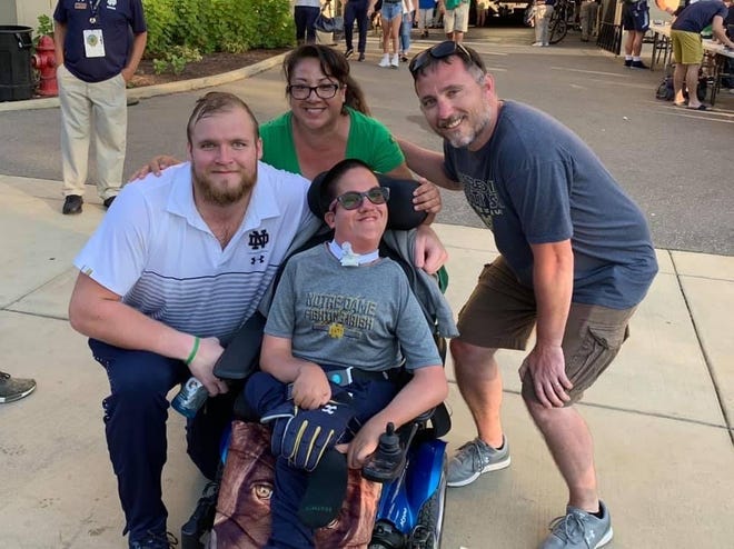 Florida State offensive lineman Dillan Gibbons (pictured here while he was attending the University of Notre Dame) with Timothy Donovan and his mother, Paula, and father, Tim.
Gibbons in July started a GoFundMe that will make it possible for Donovan, who has a rare medical condition, to attend the Seminoles' season-opener vs. Notre Dame on Sunday nght.