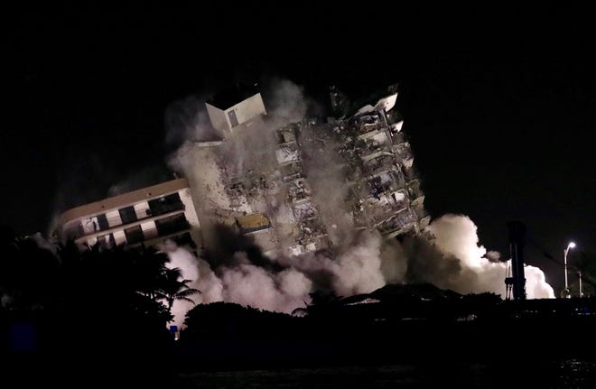 The still standing part of  Champlain Towers South Is imploded Sunday night, July 4, 2021.