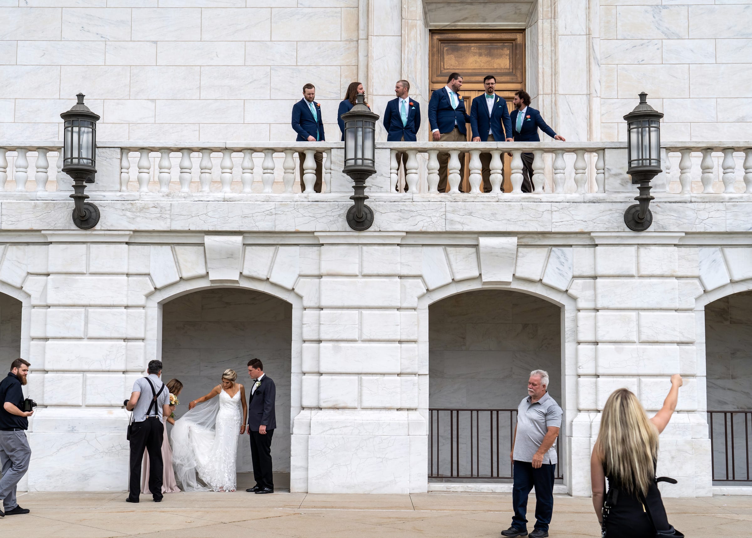 Bridal parties volley for positions as photographers prepare to take their photos on the staircase at the rear of the Detroit Institute of Arts on Saturday, June 19, 2021.