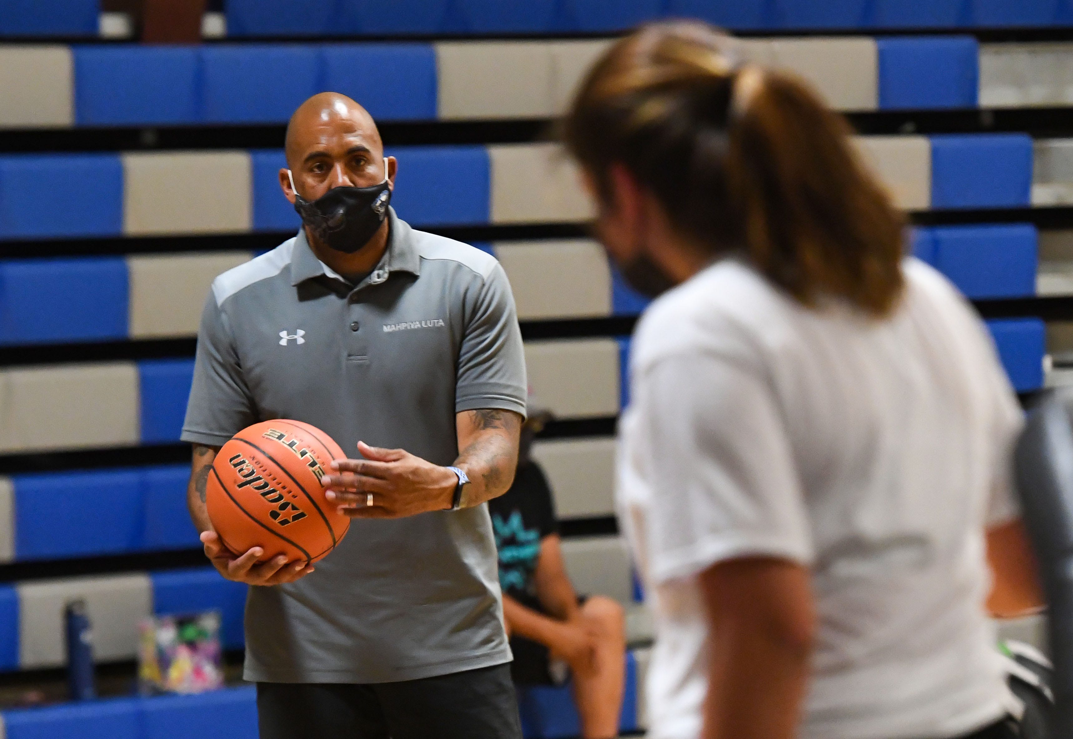 Red Cloud girls basketball coach Matt Rama works with a player on defense on June 15 on the Pine Ridge Reservation.