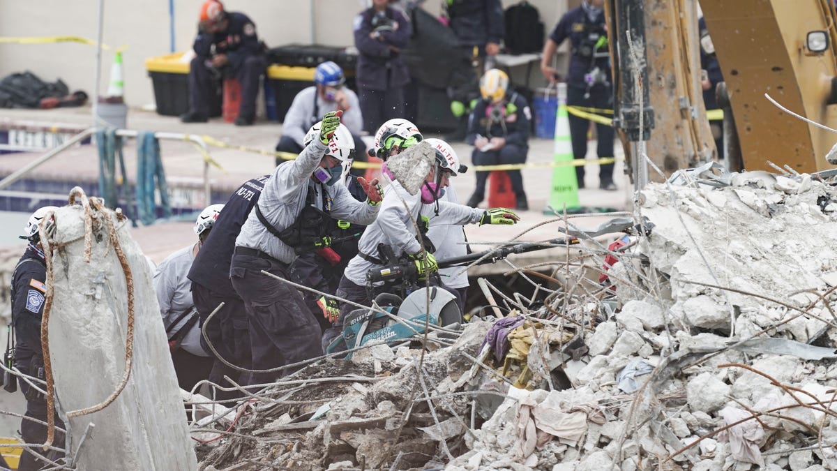 Search and rescue team members dig through rubble where the Champlain Towers South stood in Surfside, Fla. on July 6, 2021.