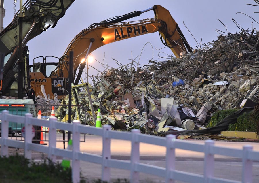 Search and recovery workers worked through the night as new teams come in at dawn to replace them at the  Champlain Towers South condominium site in Surfside, Fla. on July 6, 2021.